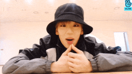 Byeongkwan lying on his stomach, talking and swinging his feet
